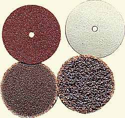 Sanding discs with holes for mandrels and types for adhesive application